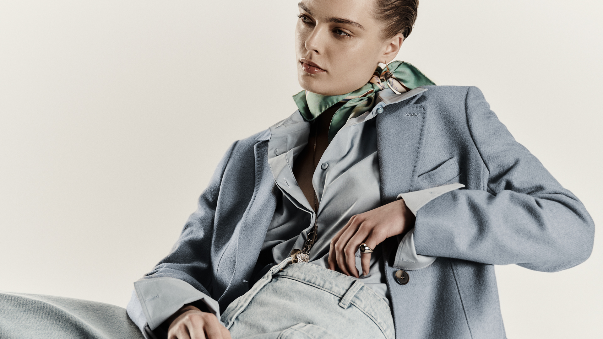 Model wears light blue Max Mara Sartoriale single-breasted blazer, with light shirt and foulard knotted at the neck.